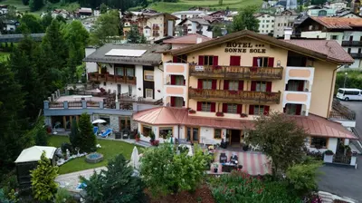 a building with a hotel on the side of it at Hotel Sonne Sole in Vigo di Fassa