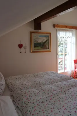 a bedroom with a bed and a window at B&B Casa Riz in Castello di Fiemme