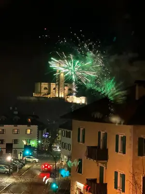 a firework display in a city at night at B&B Casa Riz in Castello di Fiemme