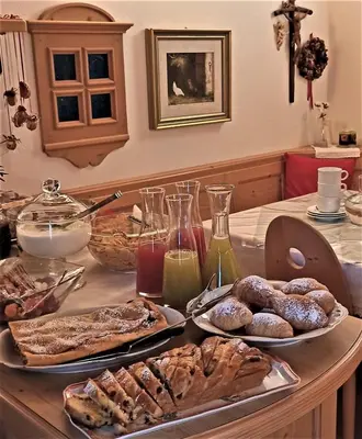 a table with two plates of pastries on it at B&B Casa Riz in Castello di Fiemme