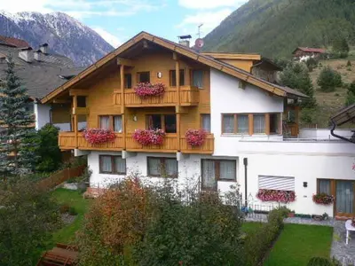 a house with a balcony with flowers on it at Residence Tauber in Valles