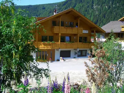 a large wooden building with a balcony at Residence Tauber in Valles