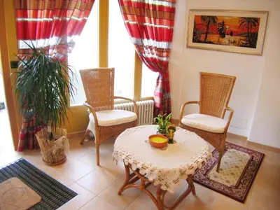 a living room with a table and chairs and a window at Residence Tauber in Valles