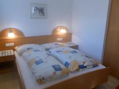 a bedroom with a bed with four pillows on it at Residence Tauber in Valles