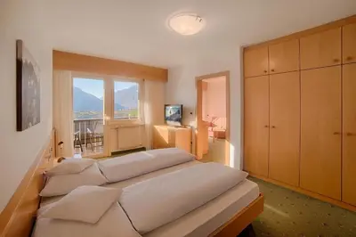 a bedroom with two beds and a window at Appartment Maria in Schenna
