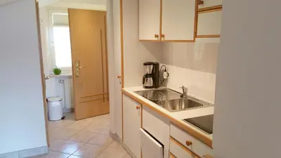 a kitchen with a sink and a counter top at Appartment Maria in Schenna