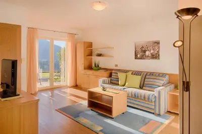 a living room with a couch and a tv at Appartment Maria in Schenna