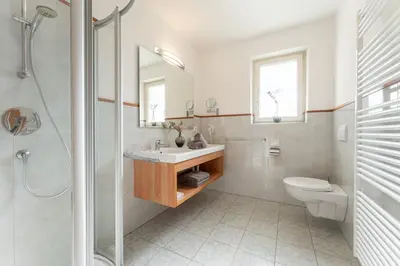 a bathroom with a sink and a toilet and a shower at Feldhof Schenna in Schenna