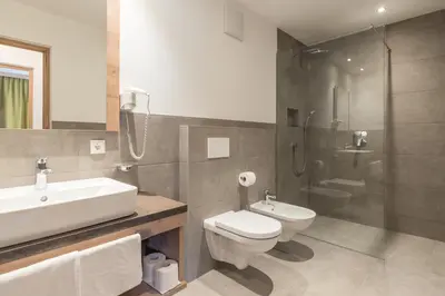 a kitchen and living room with a table and chairs at Aparthotel Panorama in Gais