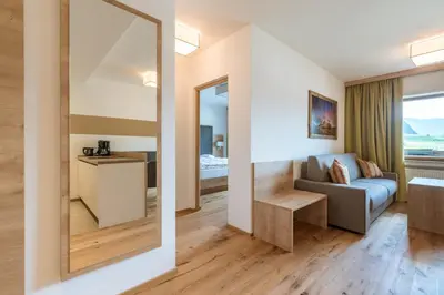 a bathroom with a toilet and a glass shower at Aparthotel Panorama in Gais