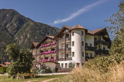 an aerial view of a resort with snow covered mountains at Aparthotel Panorama in Gais