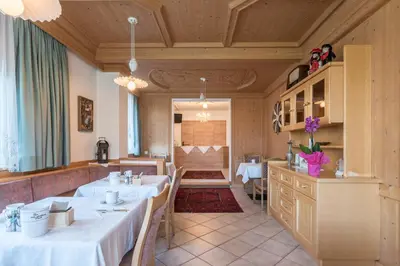 a kitchen with wooden cabinets and a rug on the floor at Aparthotel Panorama in Gais