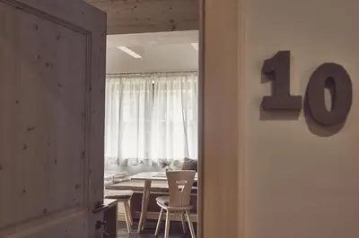 a dining room with a table and a number at B&B Mia Majon in Canazei