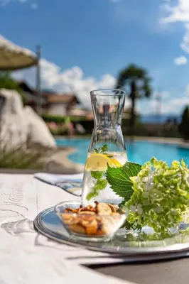 a plate of food on a table with a vase at Hotel Starkenberg in Schenna