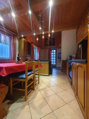 a kitchen with a table and chairs in a room at casa claudio-APPARTAMENTI IN CENTRO in Campitello di Fassa