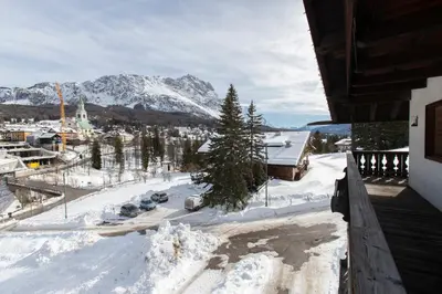 a view from a balcony of a snow covered mountain at Dolomiti Sweet Lodge in Cortina dʼAmpezzo