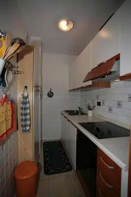 a small kitchen with a sink and a refrigerator at Residence Valfassa in Canazei
