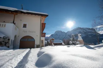 a mountain covered in snow and trees in front at Apartment Fedares in La Valle