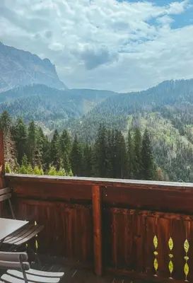a balcony with chairs and a view of the mountains at Apartment Fedares in La Valle