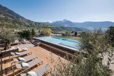 a swimming pool with a view of the mountains at Hotel Dorner B&B in Lagundo