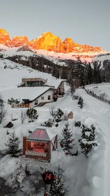 an aerial view of a house in the snow at Moseralm Dolomiti Hideaway in Nova Levante