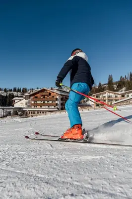 a person on skis in the snow at Moseralm Dolomiti Hideaway in Nova Levante
