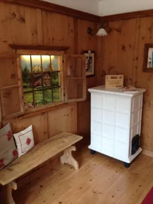 a room with a bench and a window at Appartamento Rose Di Bosco in Predazzo