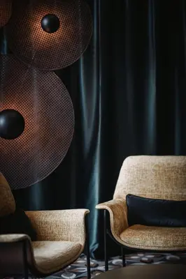 a living room with two chairs and a lamp at Nancy's Holiday Homes Dolomites in Rasùn di Sotto