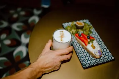 a person holding a can of food next to a plate of food at Nancy's Holiday Homes Dolomites in Rasùn di Sotto