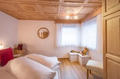a bedroom with two beds and a window at Ciasa Rosra in La Villa