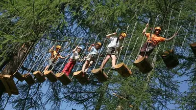 a group of people riding on a zip line at Ciasa Rosra in La Villa