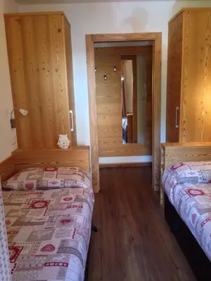 a kitchen and living room with a table and a dining room at Majon Vajolet - Apartments Luisa in Vigo di Fassa