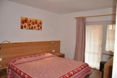 a kitchen with a table and a dining room at Majon Vajolet - Apartments Luisa in Vigo di Fassa