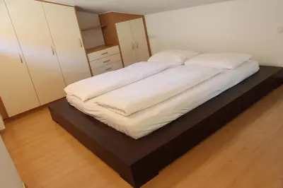 a bedroom with a bed with a black platform at Soliman in Bressanone