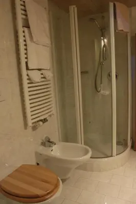 a bathroom with a toilet and a sink and a shower at Soliman in Bressanone