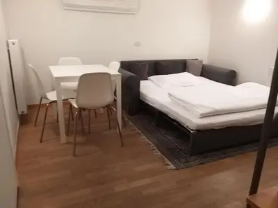 a room with a bed and a table and chairs at Soliman in Bressanone