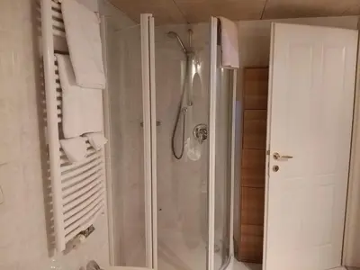 a bathroom with a shower with a glass door at Soliman in Bressanone