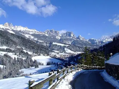 a view of a snow covered mountain with a road at Hotel De Fronz in Soraga