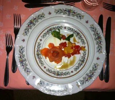 a plate of food on a table with fork and knife at Hotel De Fronz in Soraga