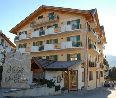 a large building with a sign in front of it at Hotel Sass Maor in Fiera di Primiero