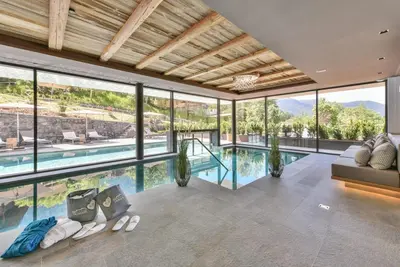 a swimming pool in front of a house at Hotel Dosses in Tires