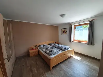 a bedroom with a bed and a window at Mesnerhof in Lauregno