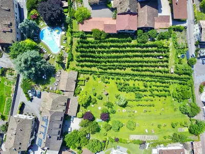 an overhead view of a garden with a park at Angerburg Blumenhotel in Appiano sulla Strada del Vino
