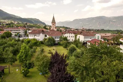 an aerial view of a town with a church at Angerburg Blumenhotel in Appiano sulla Strada del Vino