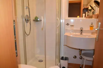 a bathroom with a shower and a sink at Angerburg Blumenhotel in Appiano sulla Strada del Vino