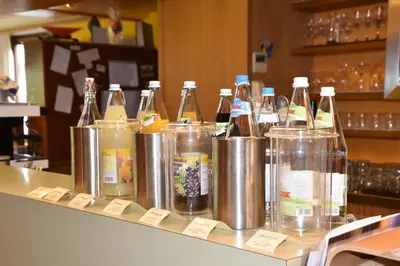 a bunch of bottles of alcohol sitting on a counter at Angerburg Blumenhotel in Appiano sulla Strada del Vino
