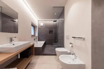a bathroom with a sink and a toilet and a shower at SOFTALPIN Garden Suites in Appiano sulla Strada del Vino