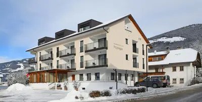 a large building with a car parked in front of it at Residence Pitzinger in Falzes