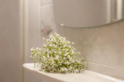 a bouquet of white flowers sitting on top of a sink at Gasthof Hanni in Merano