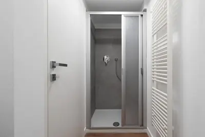 a shower with a glass door in a bathroom at Gasthof Hanni in Merano